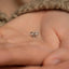 a person's hand with a tiny bow on it