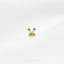 a pair of gold earrings on a white surface
