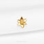 a close up of a gold brooch on a white cloth