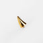a gold ring on a white surface