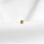 a small gold ring sitting on top of a white cloth