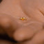 a person's hand with a gold ring on it
