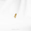 a single gold earring on a white background