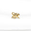 a gold brooch depicting a monkey on a white background