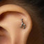 A small silver giraffe earring is visible in the person's ear.