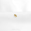 a close up of a gold ring on a white surface