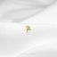 a close up of a gold ring on a white cloth