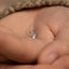 a tiny ring with a tiny hand on it