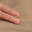 a person wearing a gold ring with a crown on it