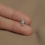 a person's hand holding a tiny silver elephant charm