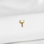a small square shaped gold earring on a white cloth