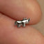 a tiny silver horse ring on someone's finger