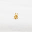 a gold spider ring sitting on top of a white sheet