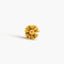 A single, golden-colored flower-shaped earring is shown against a plain white background.