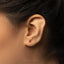 a close up of a person's ear with a red diamond in the middle