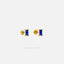 A pair of gold earrings with blue gemstones, specifically blue sapphires, set in a gold-colored earring back.