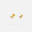 a pair of gold-colored earrings with small heart-shaped stones set in the center.