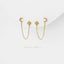 a pair of gold earrings with small diamonds hanging from the ends of the chains, set against a white background.
