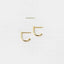 Two gold earrings with a curved design are shown against a white background.