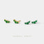 a collection of earrings with green gemstones, arranged in a row against a white background.