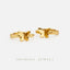 two gold-colored butterfly earrings against a white background.