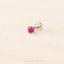 A single pink gemstone is displayed against a light background.