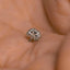 a close up of a person's hand holding a ring