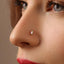 A close-up of a person's face, focusing on their nose and the small nose piercing.