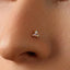A close-up of a person's nose with a small, ornate nose stud or piercing.