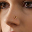 A close-up of a person's face, focusing on their nose and the small gold nose ring.
