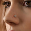 A close-up of a person's nose with a small, ornate nose stud featuring a flower-like design.