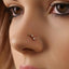 A close-up of a person's face, focusing on their nose and the three small rhinestones on the nose.