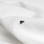 a close up of a white cloth with a black bat on it