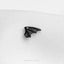 a black dragon brooch sitting on top of a white cloth