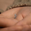 a tiny ring with a hand on top of it