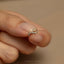 a person's hand with a ring on it