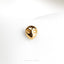 a close up of a gold ring on a white cloth
