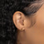 a close up of a woman's ear with a gold earring