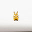 A small golden bear charm is sitting on a white surface.