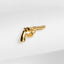 a golden gun pin sitting on top of a white cloth