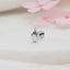a close up of a ring with a flower in the background