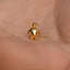 a small gold penguin brooch sitting on someone's hand