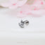 a silver cat ring sitting on top of a table