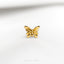 a close up of a gold colored butterfly brooch