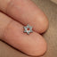 a person's finger with a small star of david pin on it