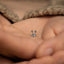 a person holding a tiny silver object in their hands