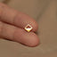 a person's finger with a gold ring on it
