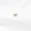 a gold bow ring on a white background