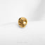a gold skull ring on a white surface