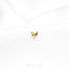 a close up of a gold earring on a white cloth